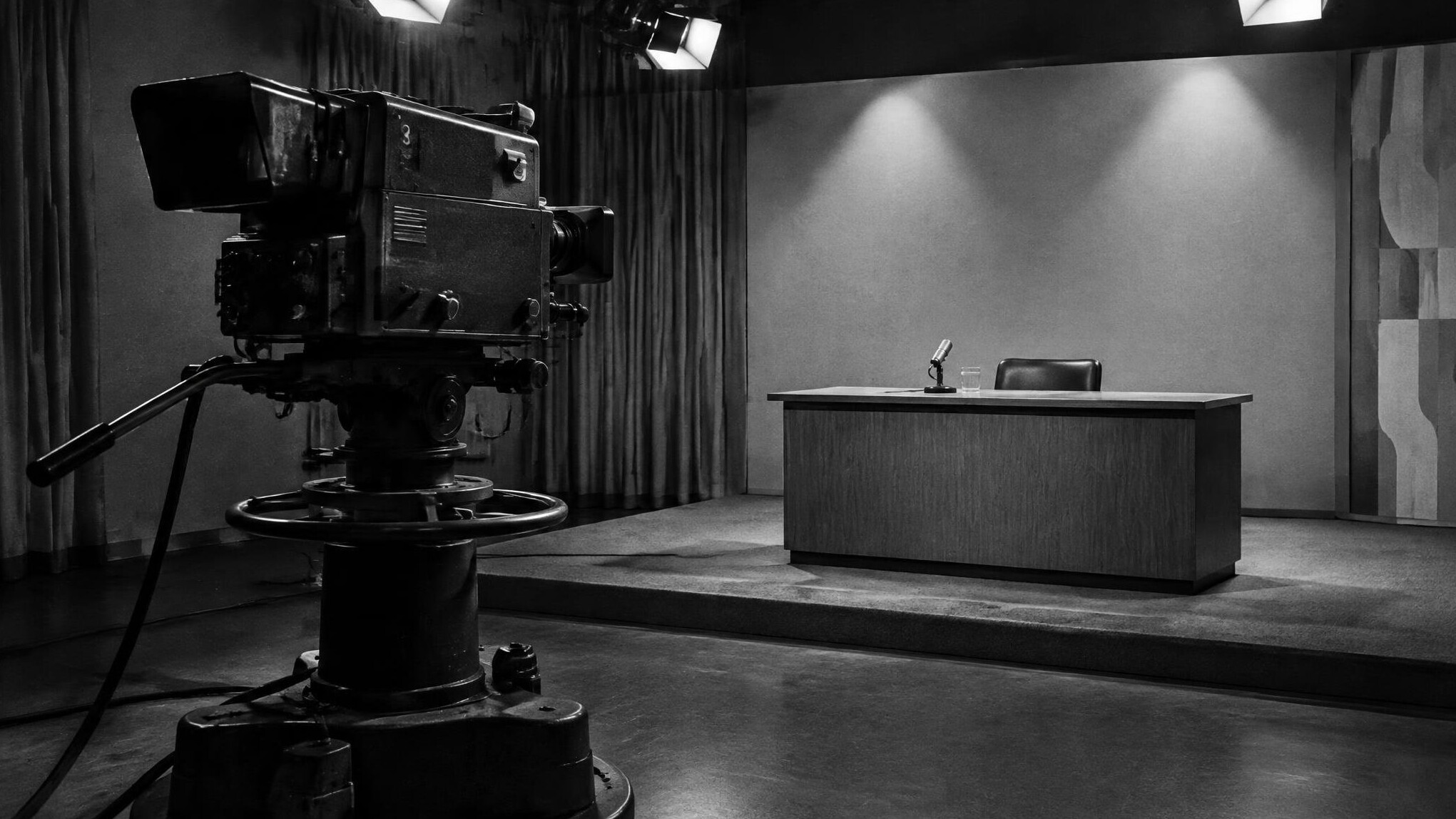 Black and white photograph of a vintage television studio with large camera