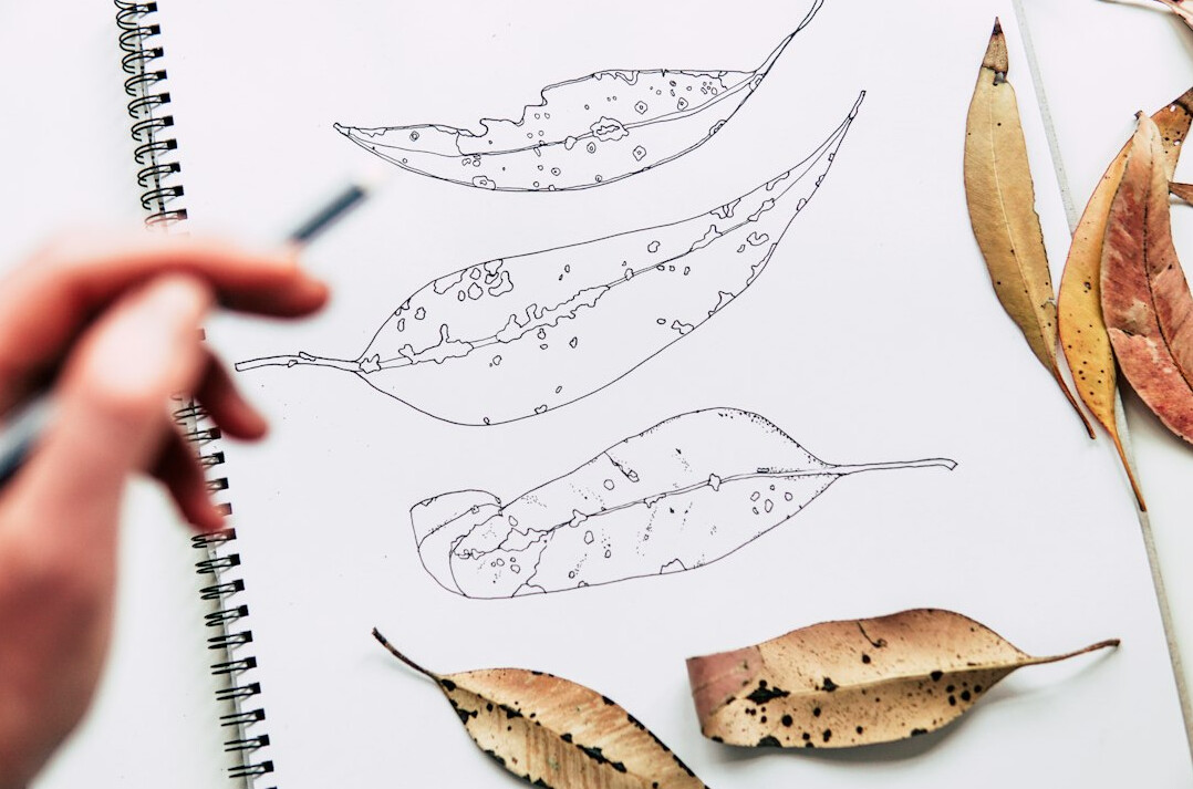 Hand writing in a notebook with a pen